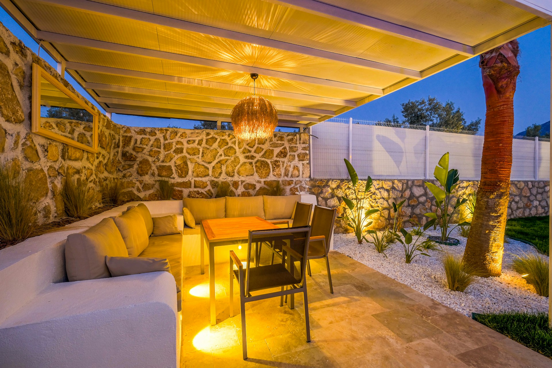 a-patio-with-a-table-couches-and-lights